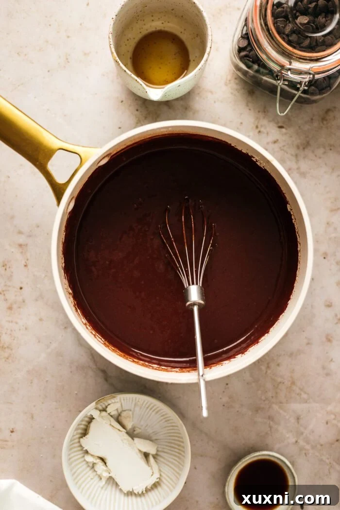 Quick and Easy Vegan Chocolate Pudding Dream 6 Vegan chocolate pudding mixture being heated and thickened in a saucepan on the stove.