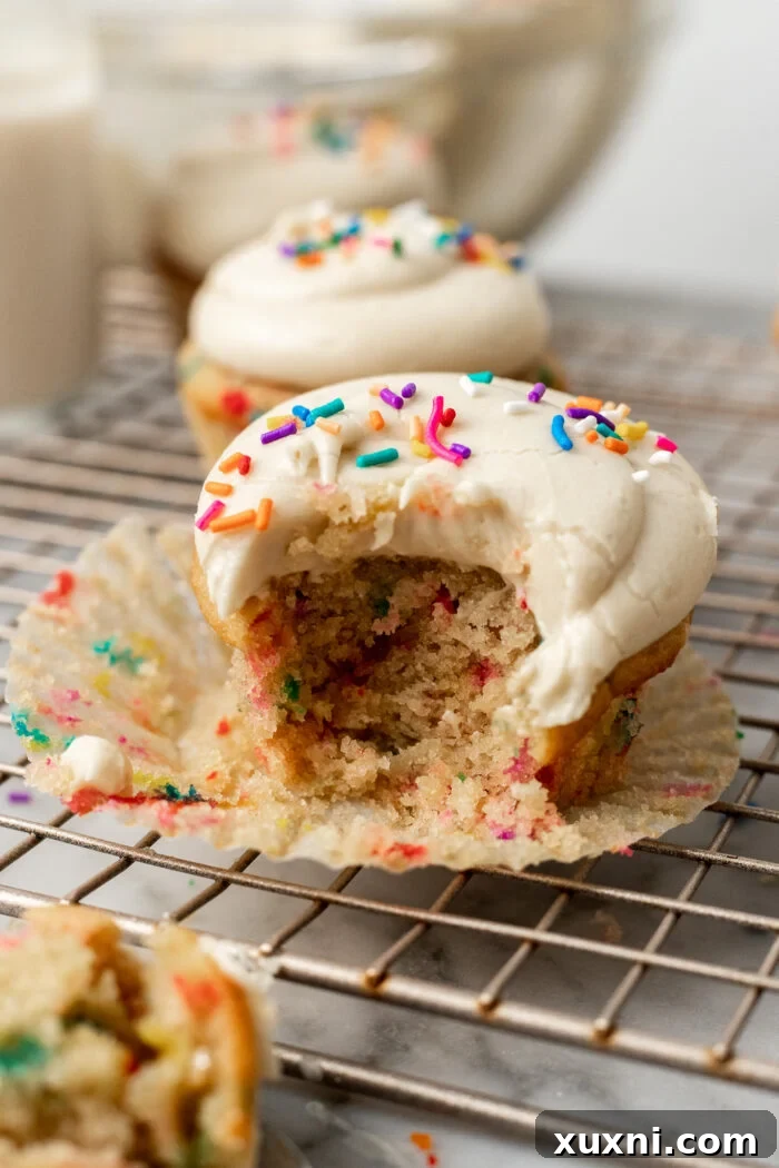 Vegan Funfetti Cupcakes Perfectly Moist for Four Days 3 bitten funfetti cupcake with frosting
