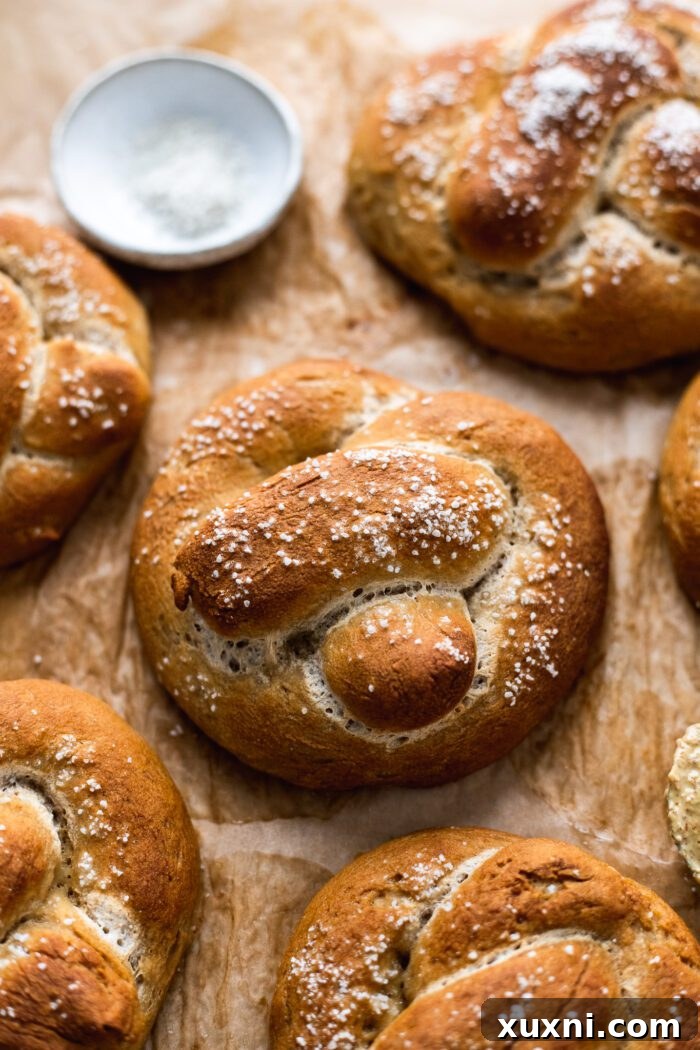 Pillowy Soft Gluten Free Vegan Pretzels 12 vegan gluten free soft pretzels on parchment paper