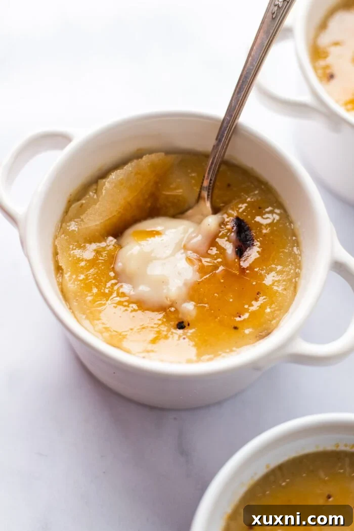 A beautifully plated vegan crème brûlée in a ceramic ramekin, showcasing its creamy texture and golden caramelized top.