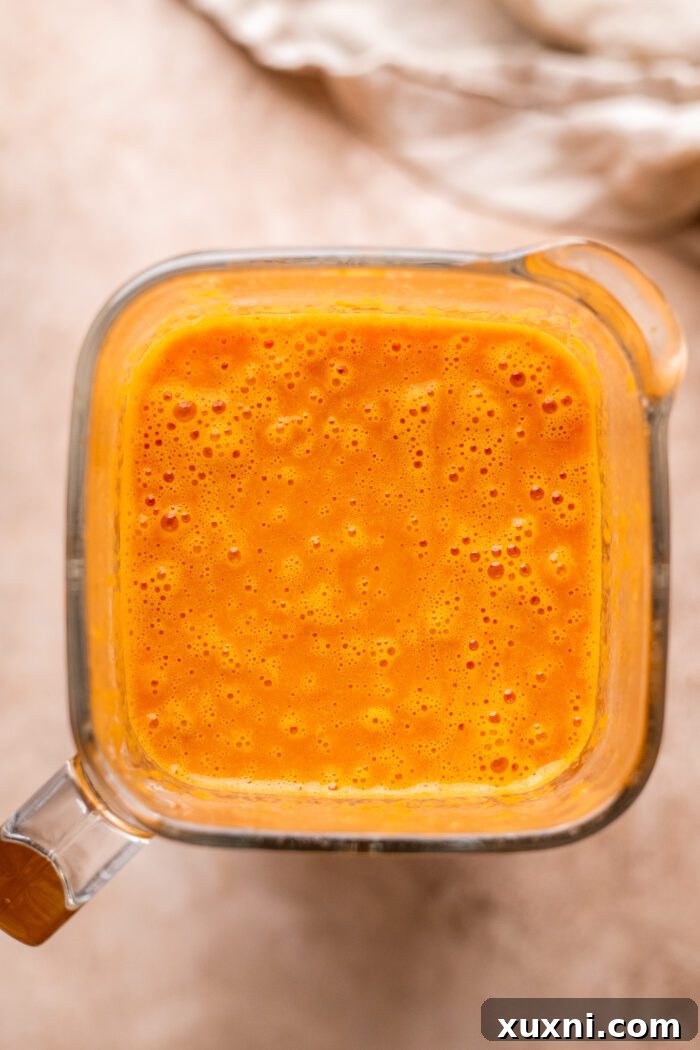 Close-up of freshly blended vegan vodka sauce in a blender, perfectly smooth and creamy.