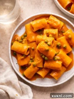 vegan penna alla vodka on a plate with peas
