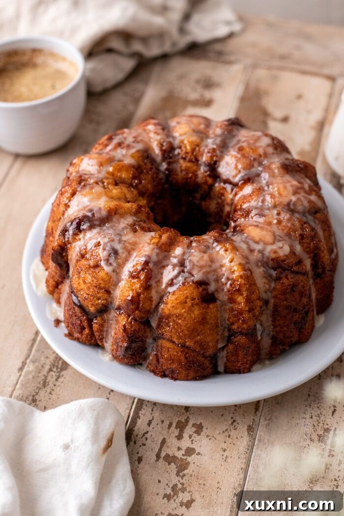 The Classic Soft and Fluffy Gluten-Free Monkey Bread 2 A golden-brown, soft, and fluffy gluten-free monkey bread on a white plate, ready to be enjoyed.