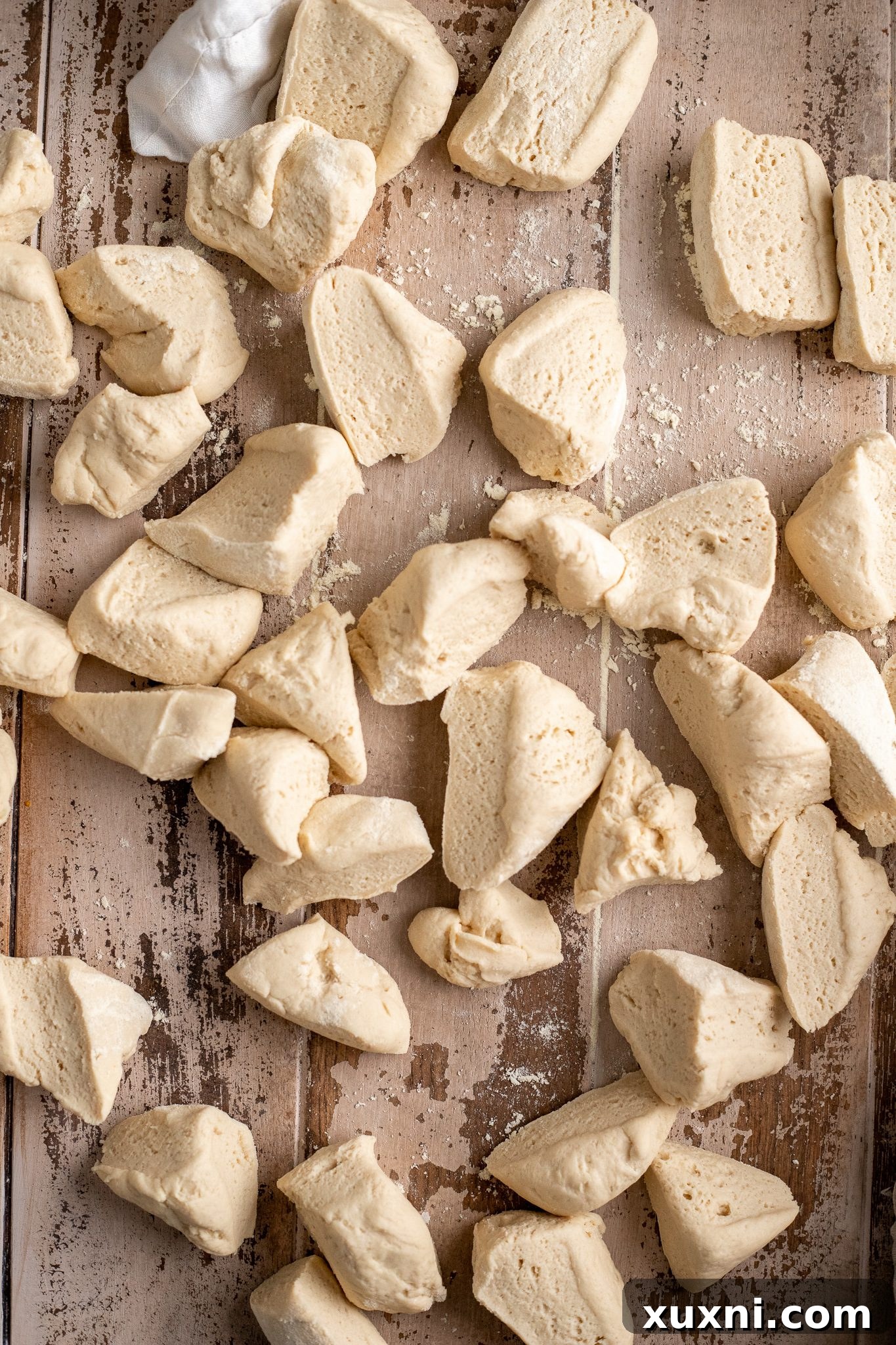 The Classic Soft and Fluffy Gluten-Free Monkey Bread 5 Gluten-free monkey bread dough expertly divided into small, uniform pieces on a cutting board, ready for coating.