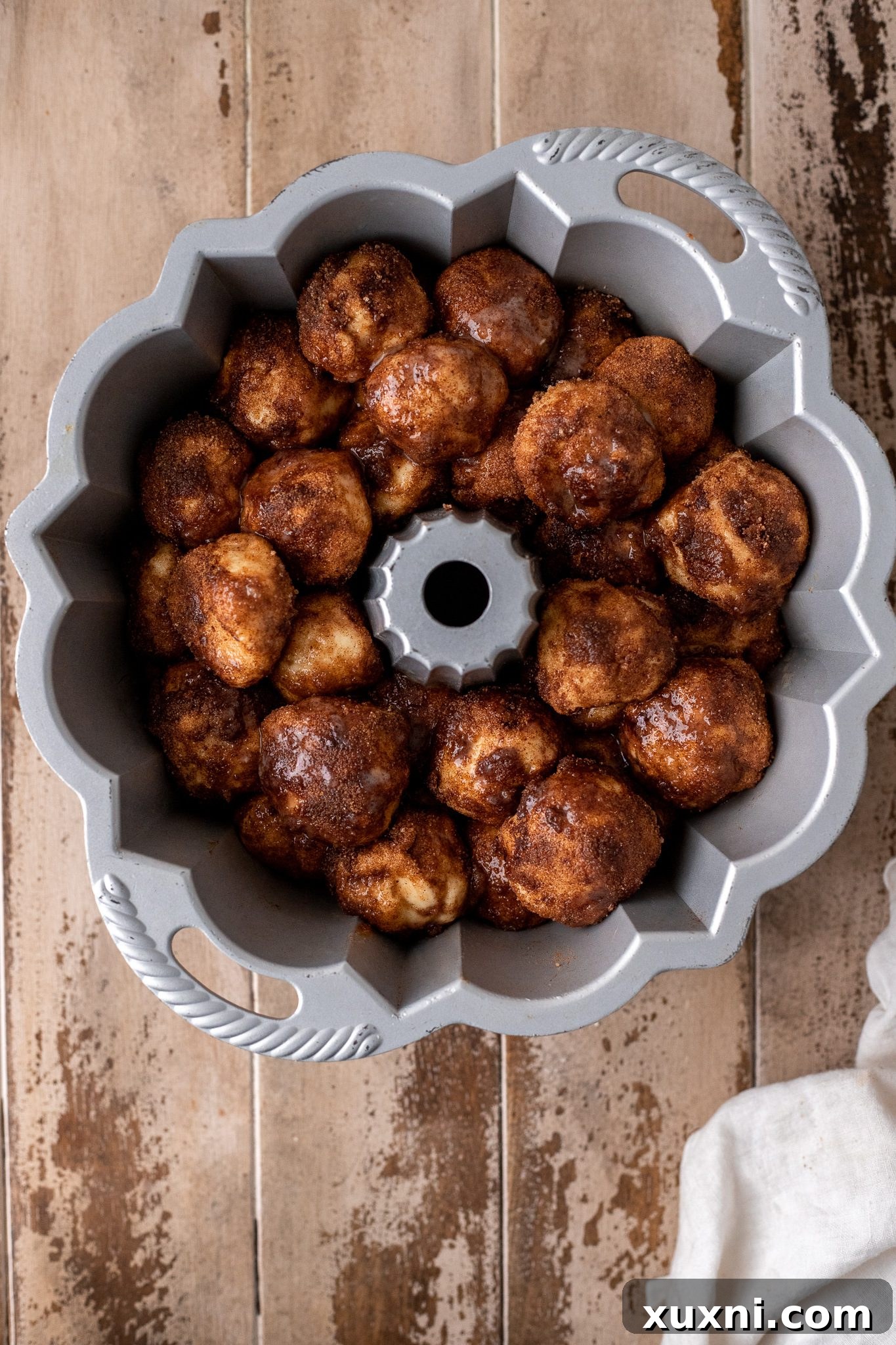 The Classic Soft and Fluffy Gluten-Free Monkey Bread 8 Unrisen gluten-free monkey bread dough balls meticulously arranged in a bundt pan, before the proofing stage.