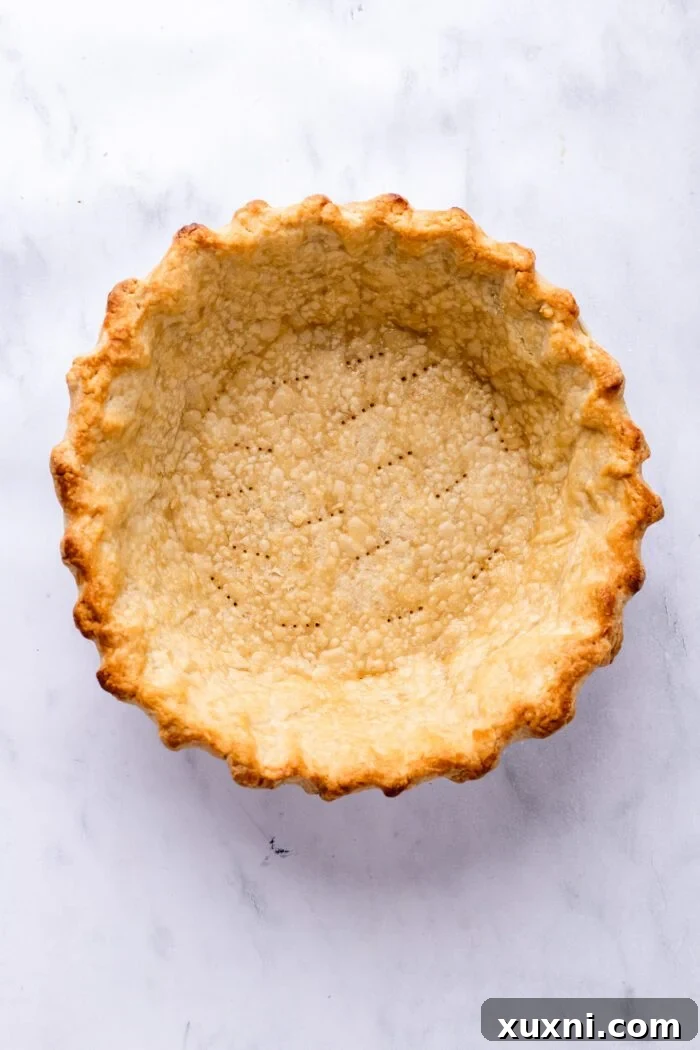 Beautifully baked golden-brown gluten-free pie crust, ready for filling.