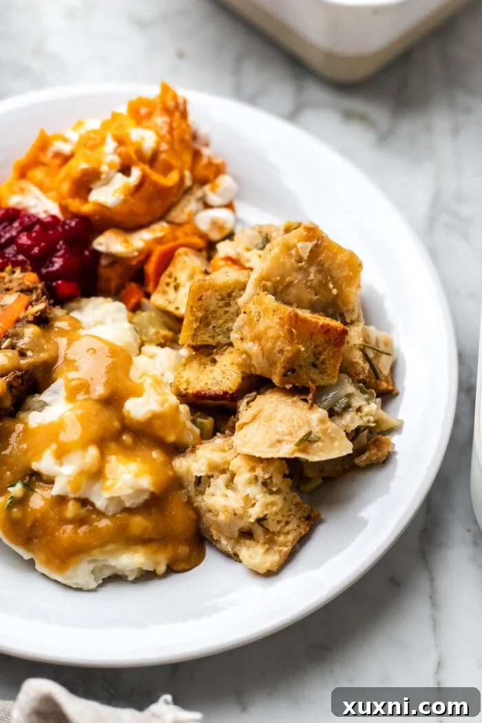 close up of vegan stuffing, a detailed close-up showing the texture and herbs in the baked vegan stuffing