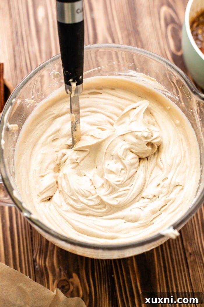 Ultimate Gooey Vegan Pecan Pie Cheesecake 8 Vegan pecan pie cheesecake batter in a mixing bowl, showcasing its smooth texture.