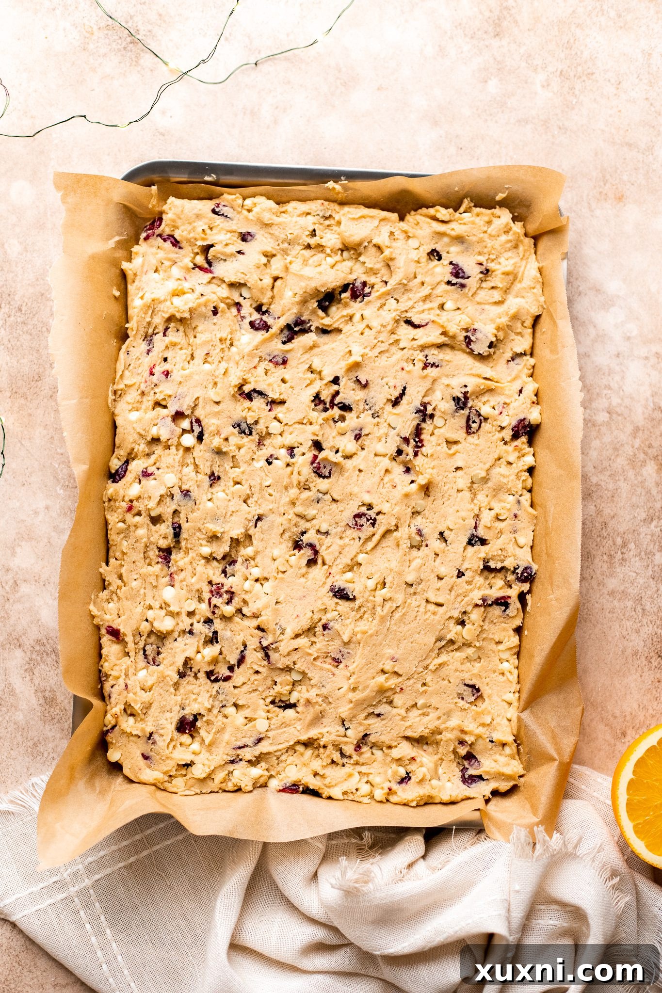 cranberry bliss bar dough before baking, spread in pan
