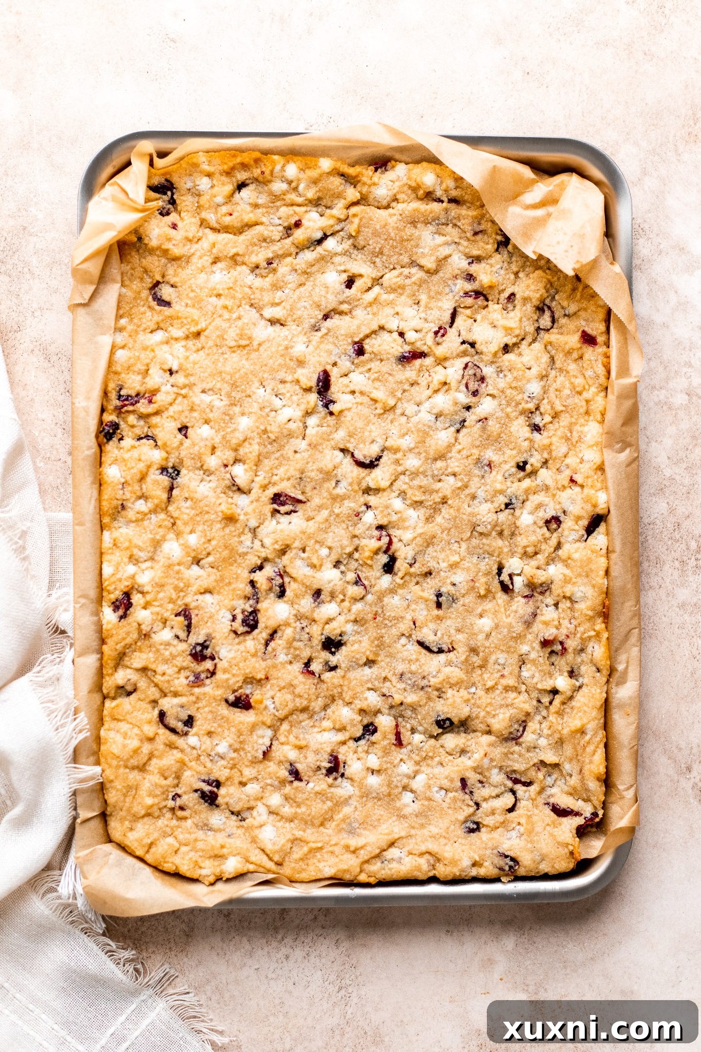 baked vegan cranberry bliss bars, golden edges visible