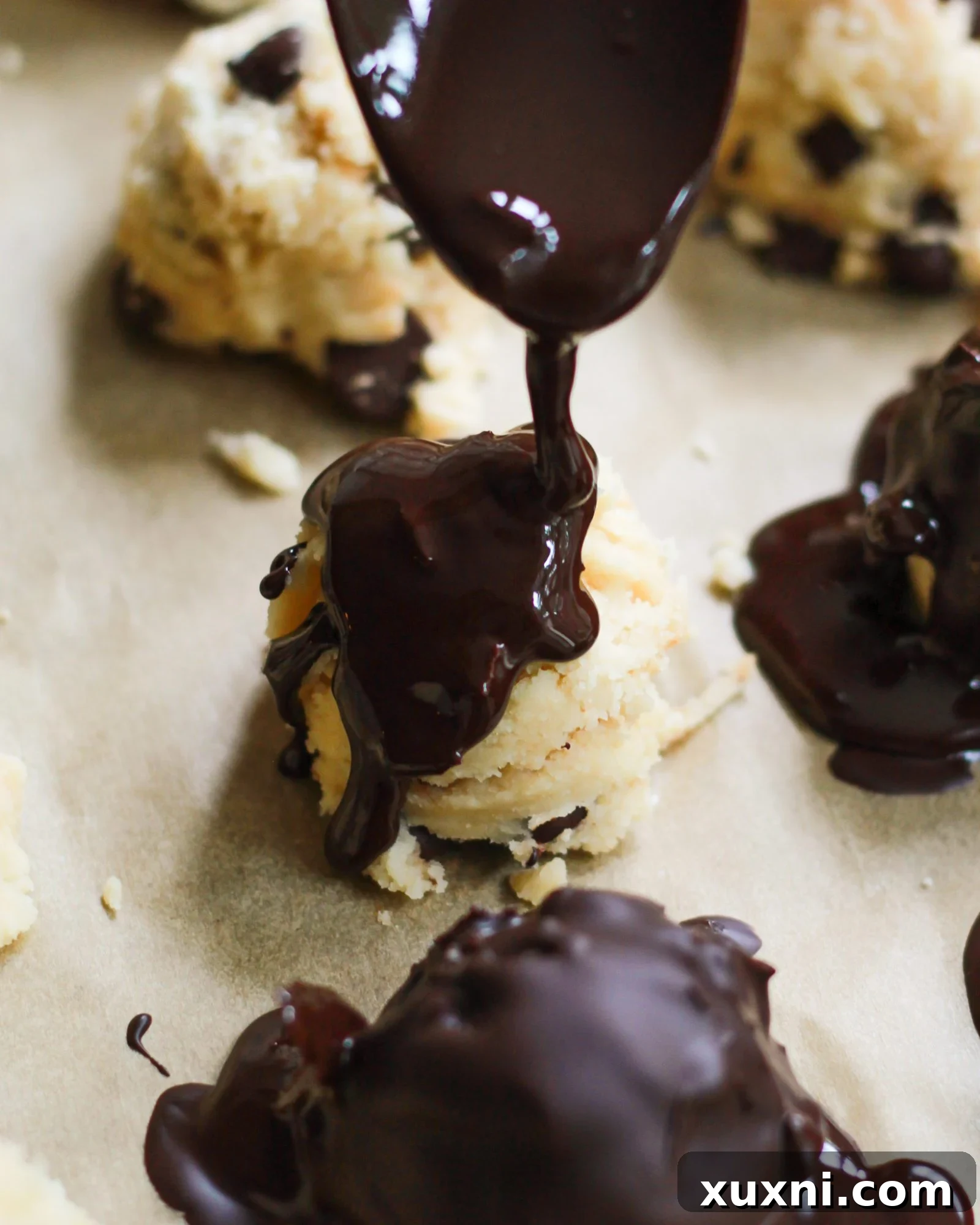 drizzling chocolate over raw cookie dough
