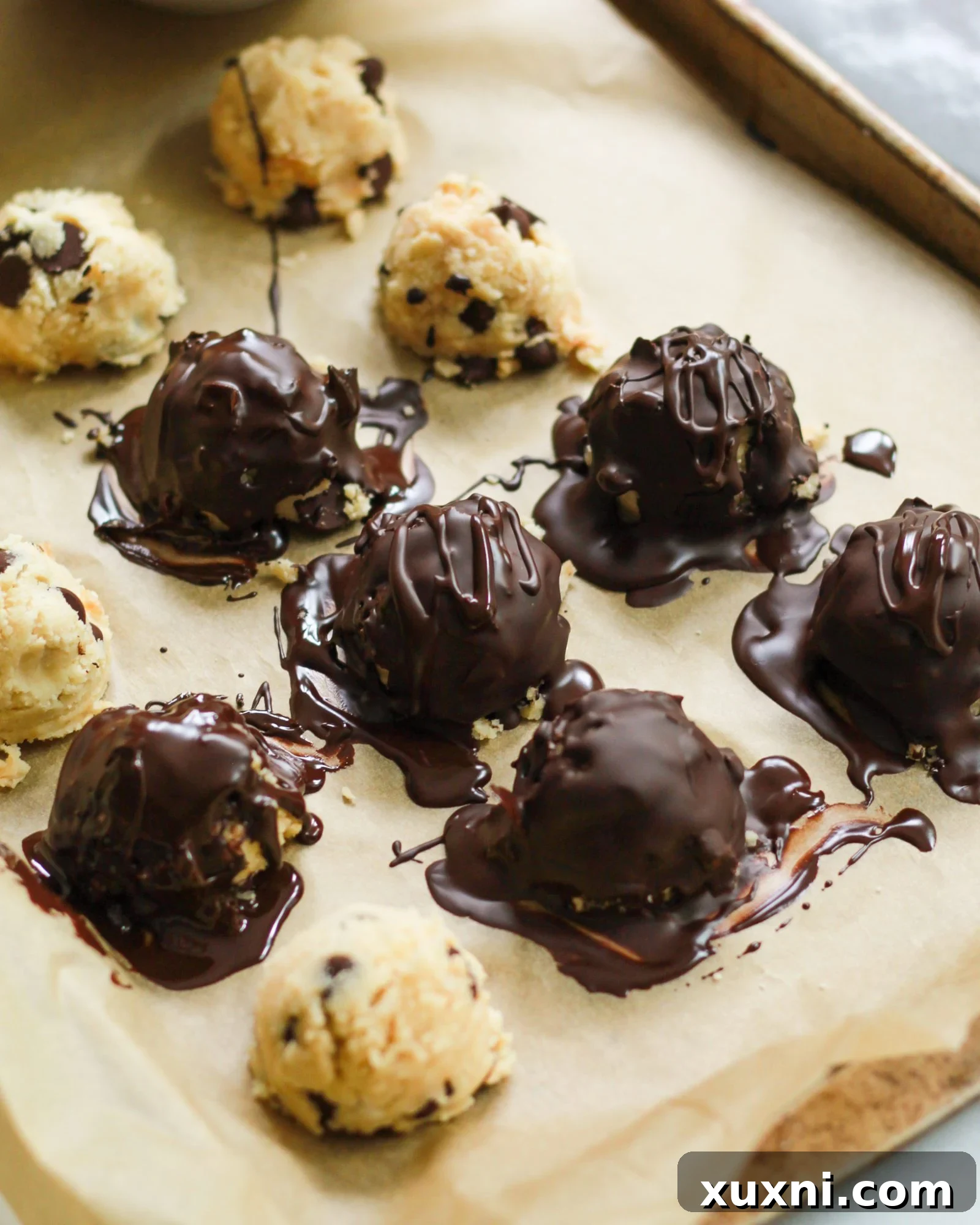 cookie dough truffles on parchment paper