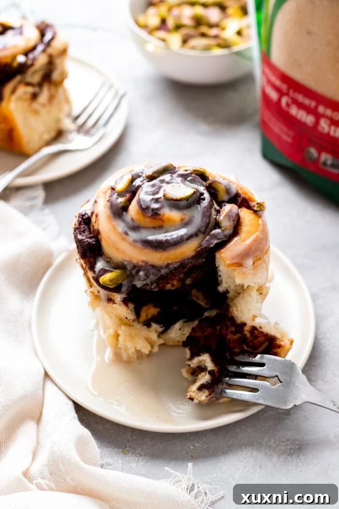 Close-up of a stack of Vegan Chocolate Pistachio Sweet Rolls, showing the rich chocolate and pistachio layers