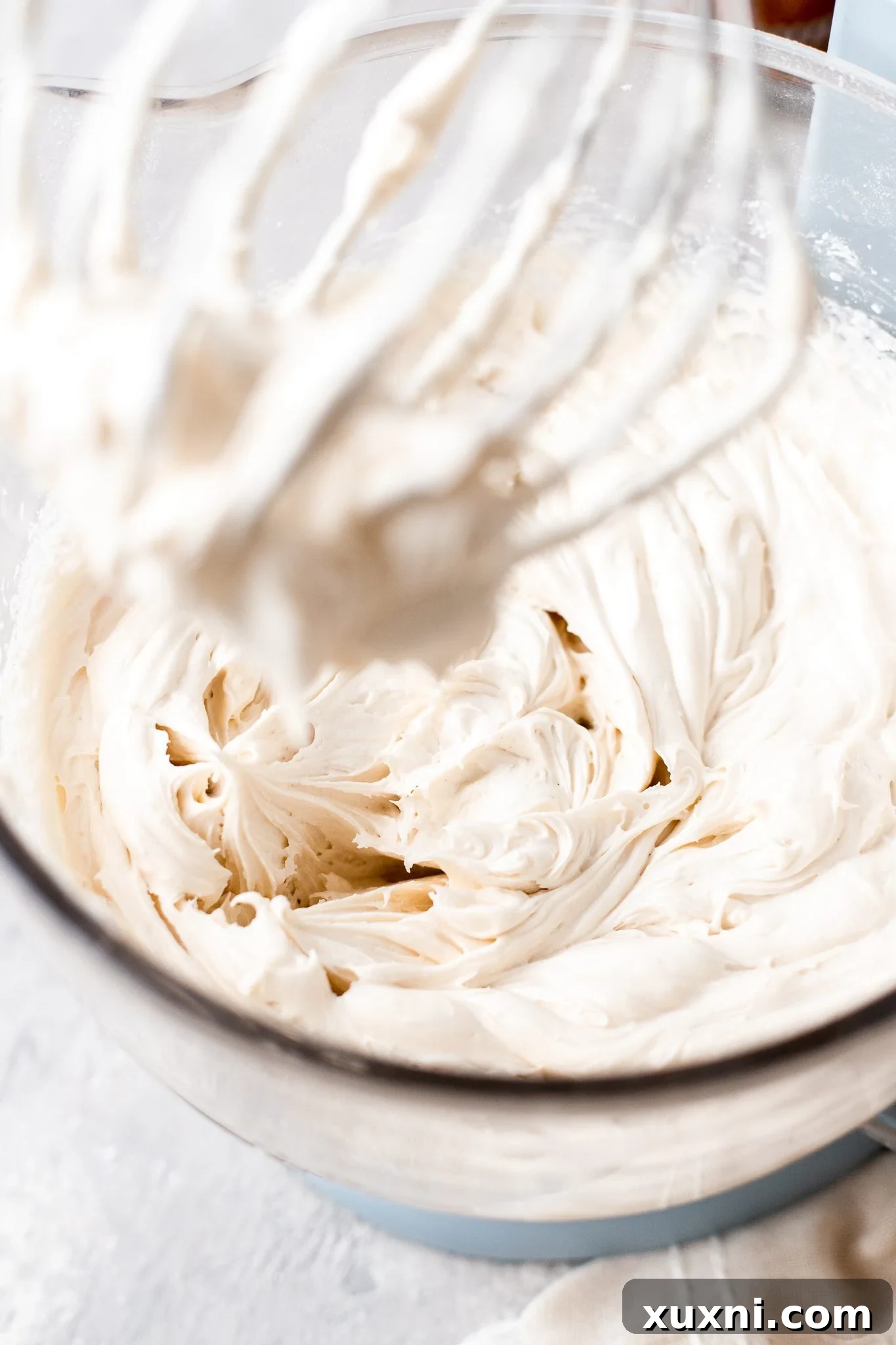 Mastering Pipeable Vegan Cream Cheese Frosting 6 adding sifted powdered sugar to vegan frosting