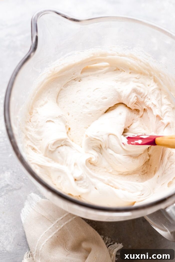 Mastering Pipeable Vegan Cream Cheese Frosting 8 bowl of vegan cream cheese frosting with a spoon in it