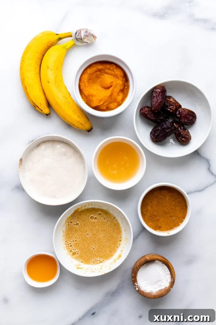 A top-down view of all 10 vegan egg substitutes laid out on a marble background, clearly labeled and ready for use in cooking and baking.