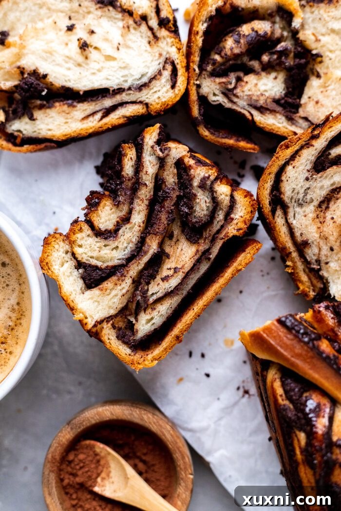 Stacked slices of vegan chocolate babka with a perfect swirl pattern