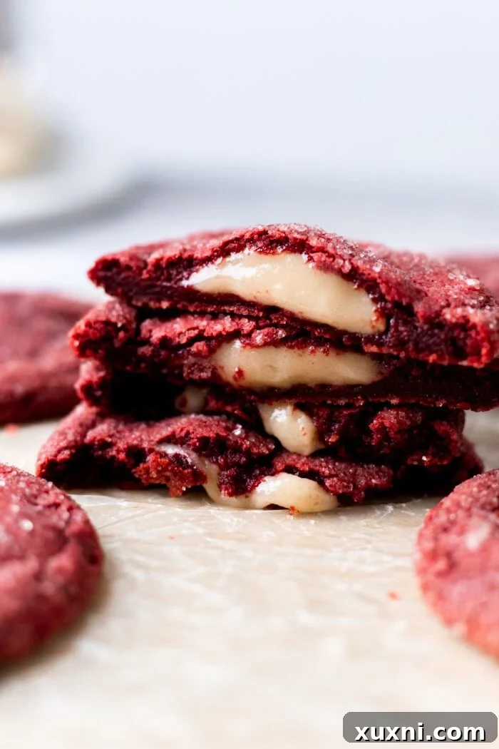 stacked red velvet cookies with cream cheese filling and bite