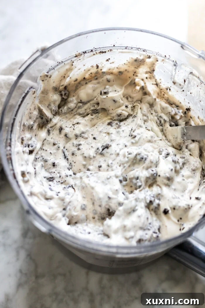 The finished, smooth, and creamy vegan cheesecake batter in a bowl, ready to be poured into the crust.