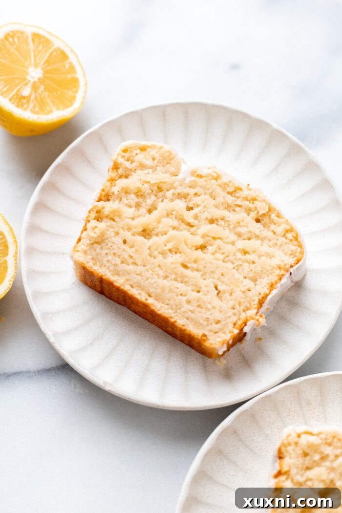 Slice of vegan lemon pound cake showcasing its fluffy texture and moist crumb.