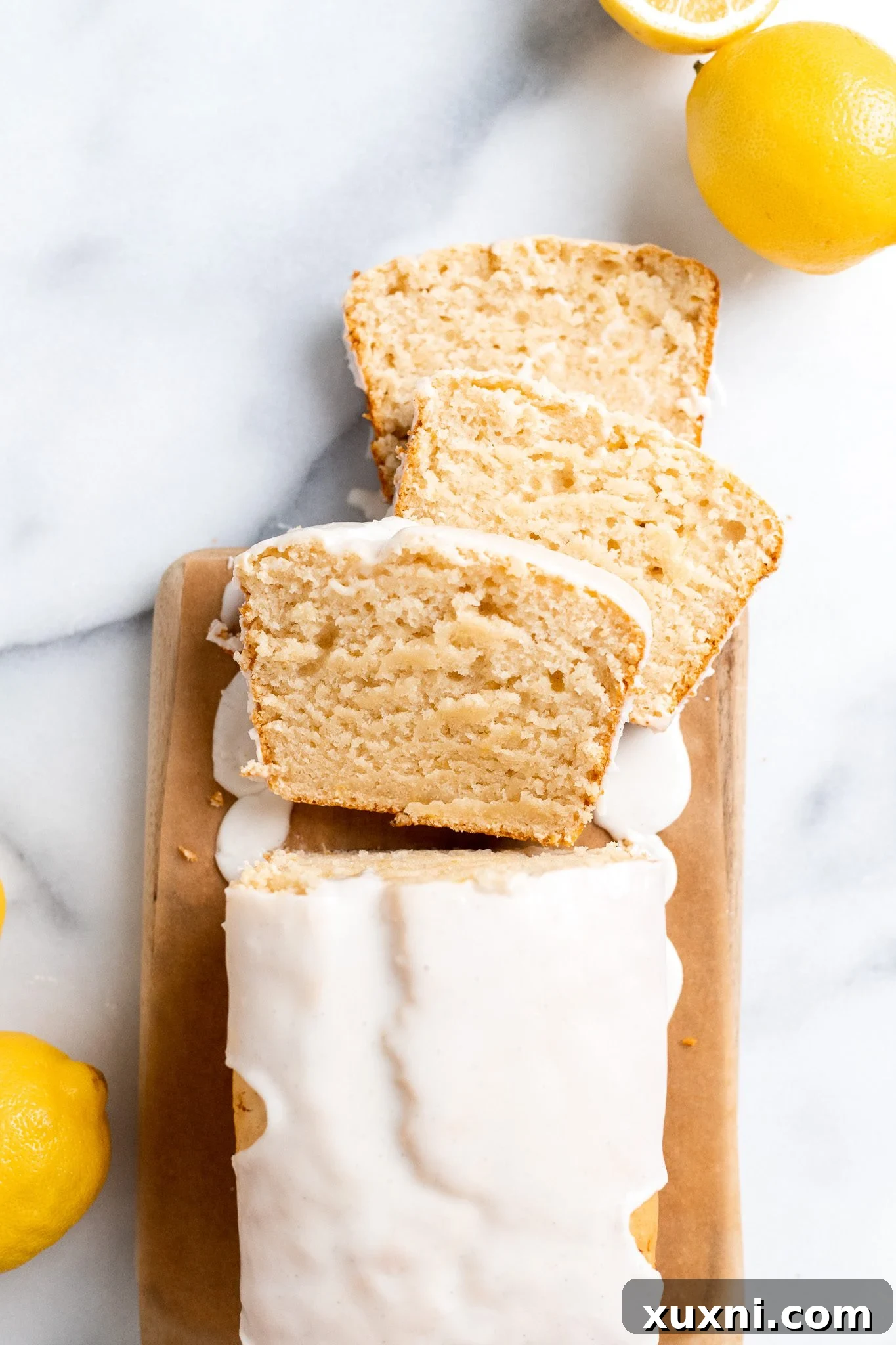 Various slices of vegan lemon pound cake artfully arranged.