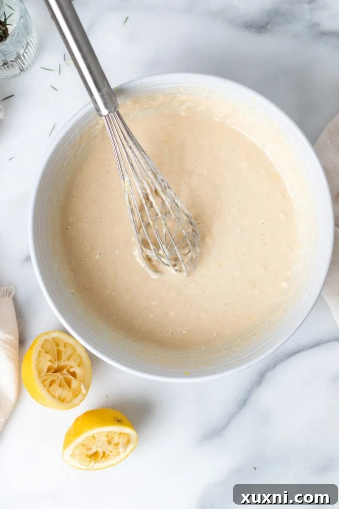 Vegan lemon pound cake batter in a mixing bowl, showcasing its smooth consistency before baking.