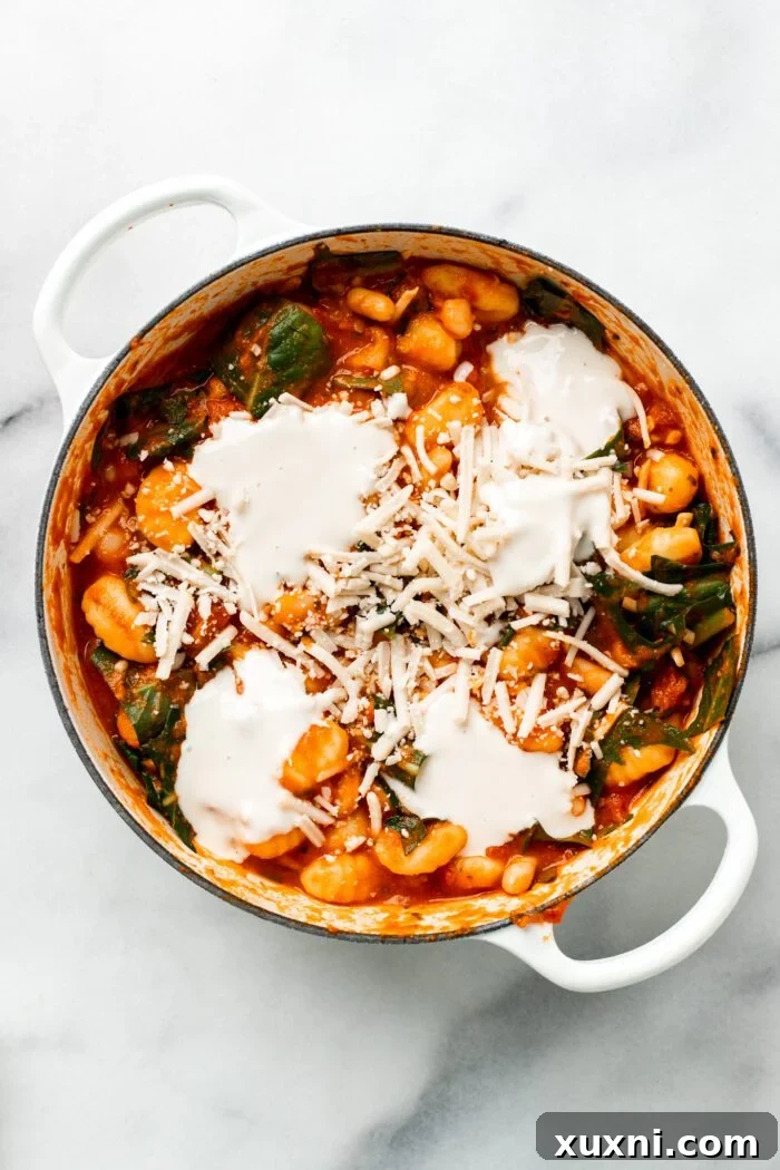 25-Minute No-Boil Vegan Cheesy Baked Gnocchi with Beans 11 Vegan baked gnocchi topped with extra vegan cheese before baking.