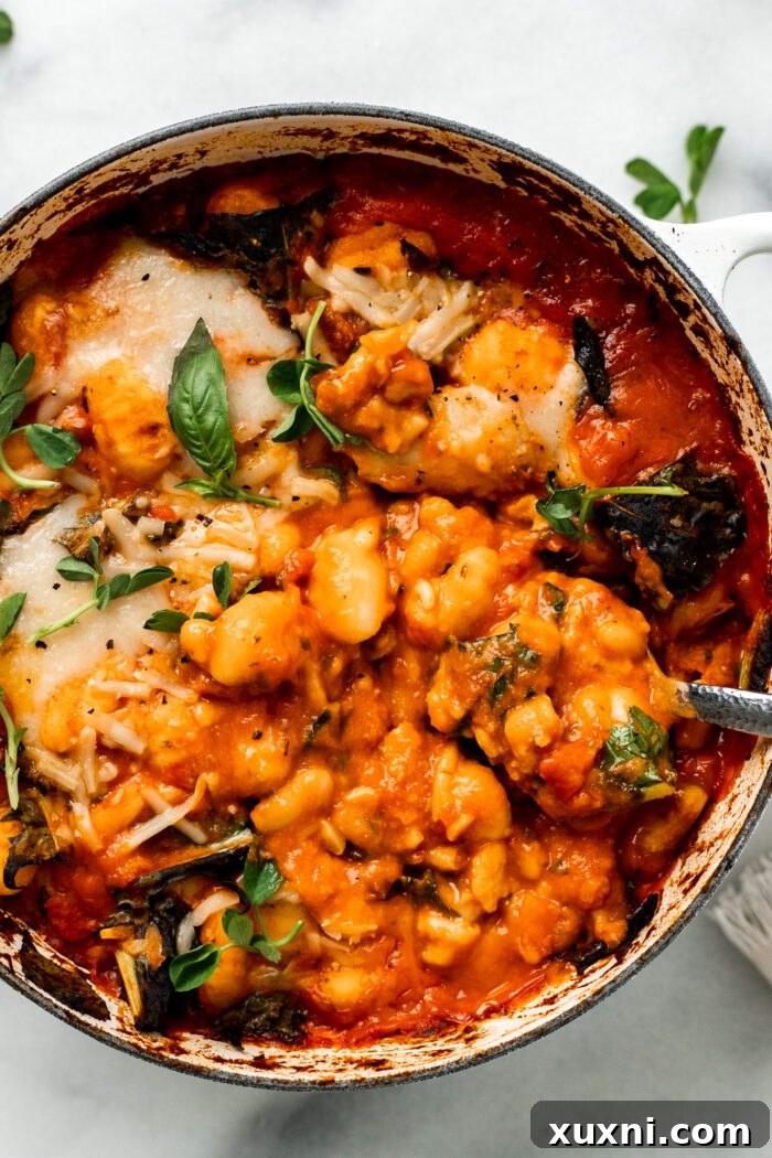 25-Minute No-Boil Vegan Cheesy Baked Gnocchi with Beans 14 The finished vegan baked gnocchi, steaming and ready to be served, in a Dutch oven.