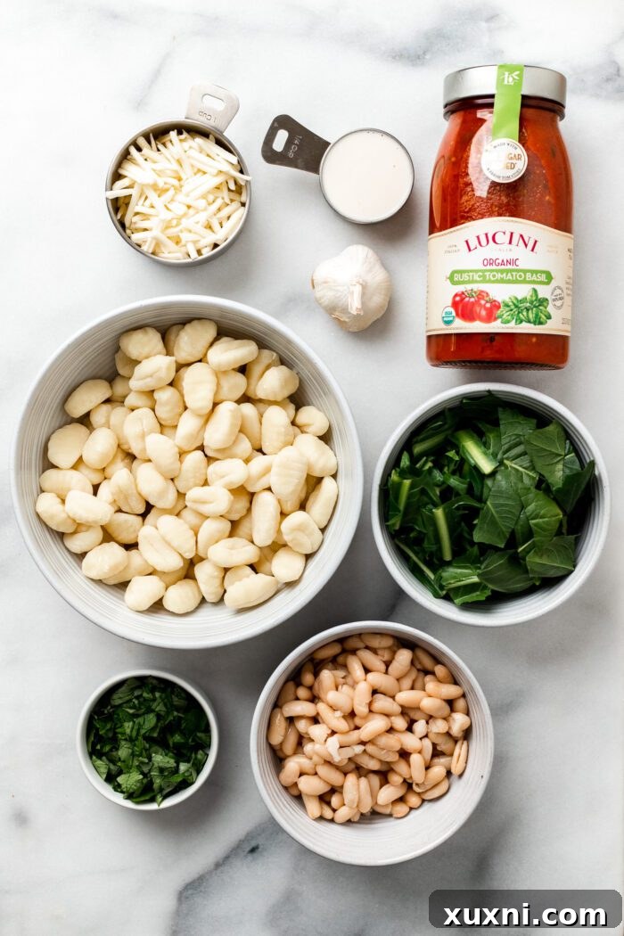 25-Minute No-Boil Vegan Cheesy Baked Gnocchi with Beans 4 All the vegan baked gnocchi ingredients laid out on a marble countertop.