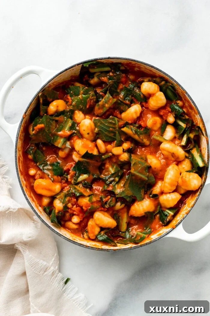 25-Minute No-Boil Vegan Cheesy Baked Gnocchi with Beans 9 All ingredients, including gnocchi, thoroughly mixed in the tomato sauce within the Dutch oven.