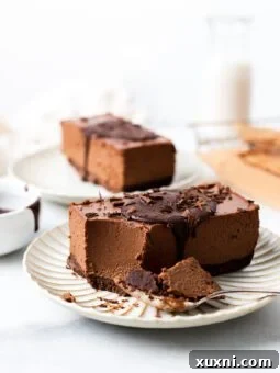 vegan mousse bar on a plate with a bite out of it