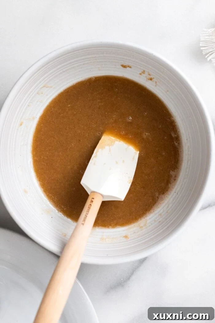 Wet ingredients (brown butter, sugars, vanilla, yogurt) thoroughly mixed together in a large mixing bowl.