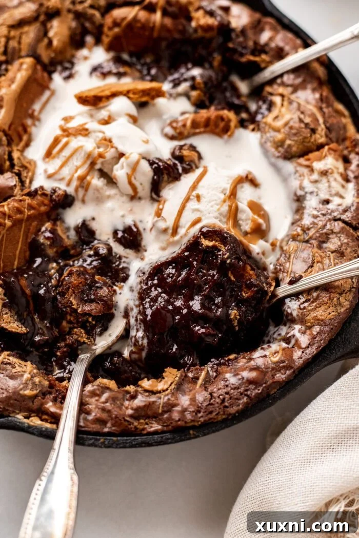 Close-up of a warm vegan Biscoff Brownie skillet, showing the fudgy texture and melted cookie butter.