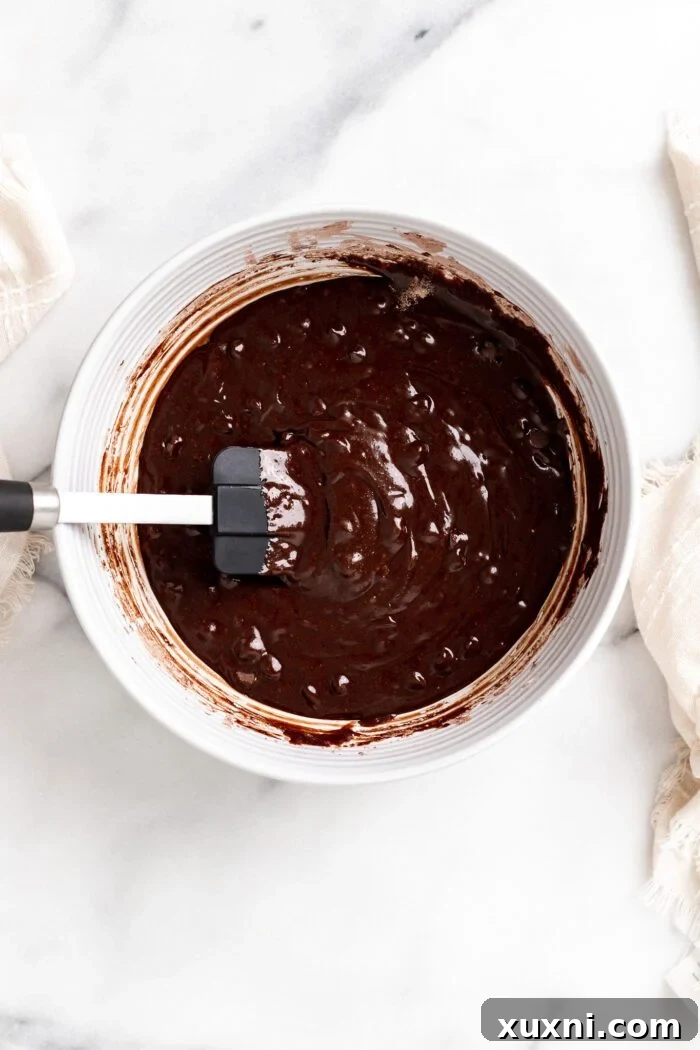 Brownie batter in a mixing bowl, ready for assembly.