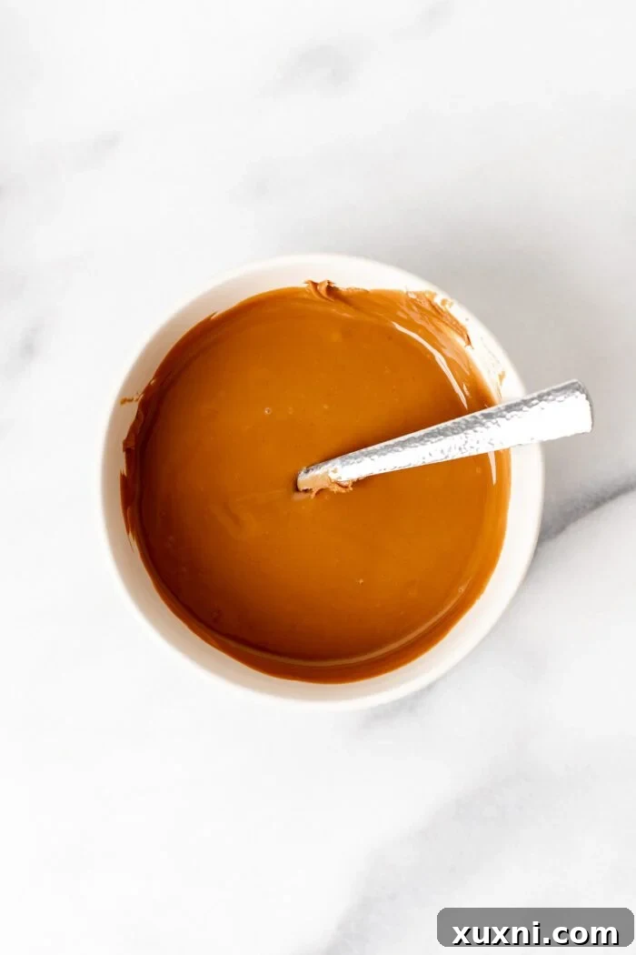 Melted Biscoff cookie butter in a small bowl.
