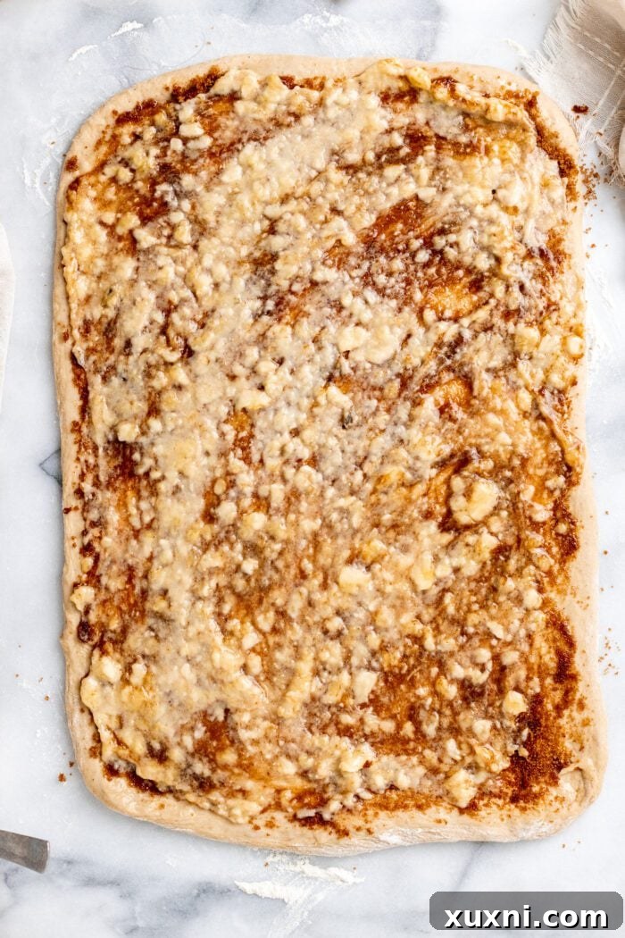 Mashed banana filling spread over cinnamon-sugar mixture