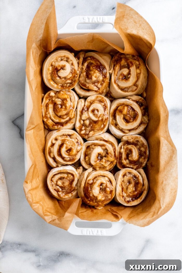 Unbaked banana bread cinnamon rolls arranged in a baking dish