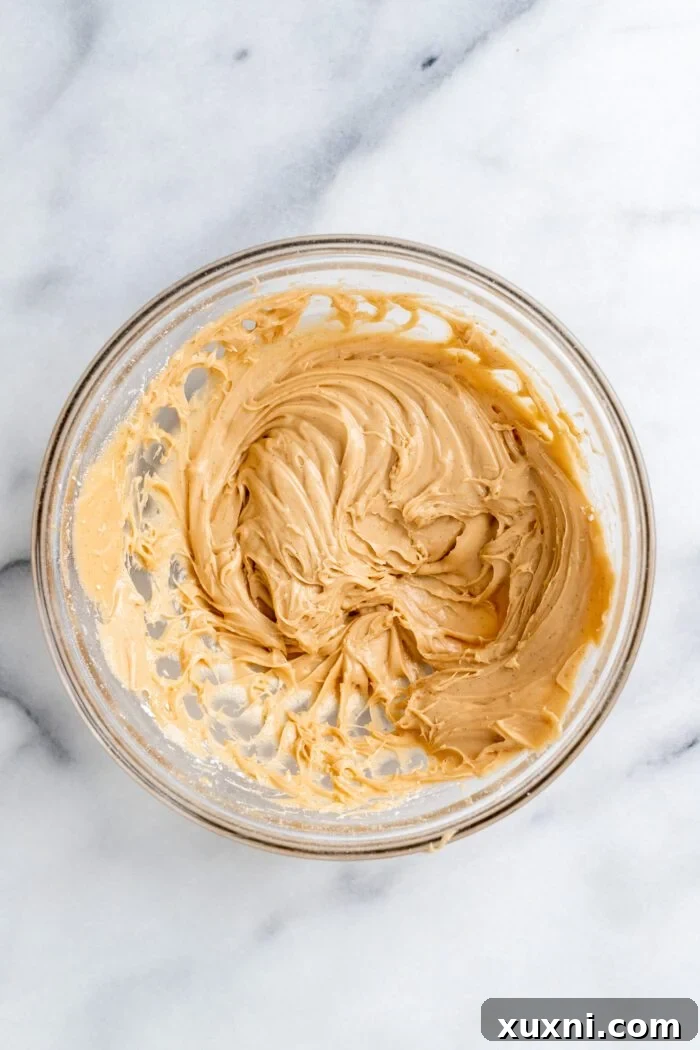 Smooth and creamy peanut butter cream cheese frosting in a bowl