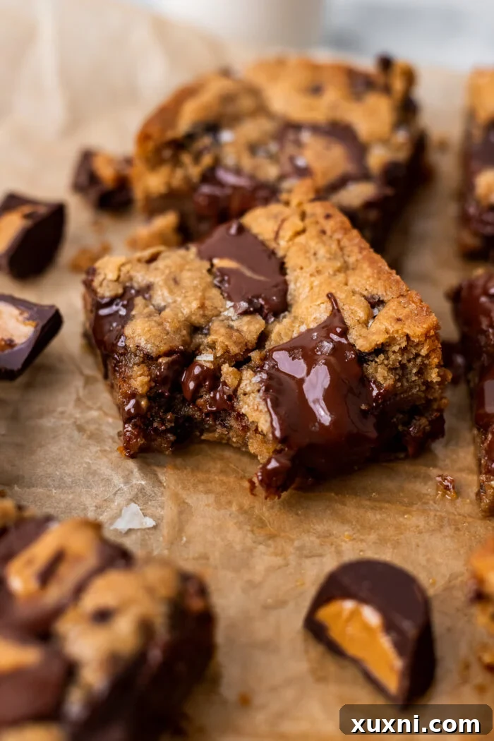 Bitten vegan peanut butter blondie showcasing its soft, molten interior and chocolate chunks