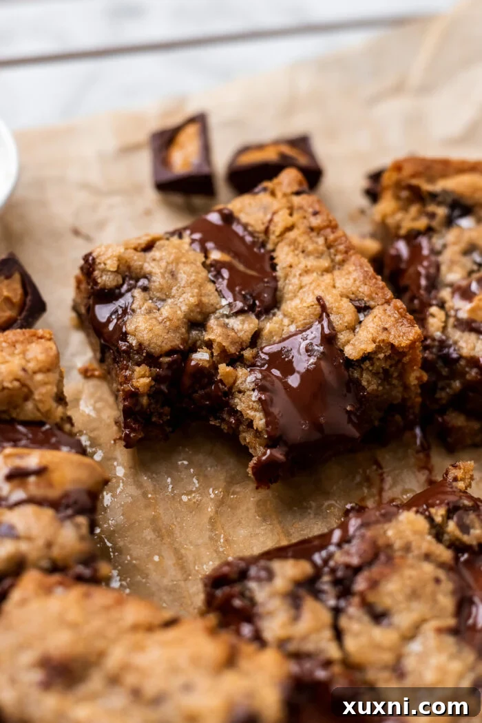 Bitten vegan peanut butter cookie bar with a soft, gooey center and chocolate chunks
