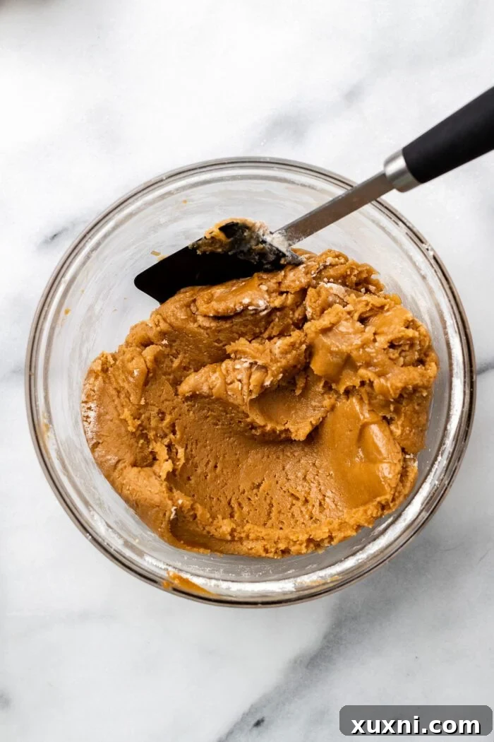 Folding dry ingredients into the peanut butter blondie batter