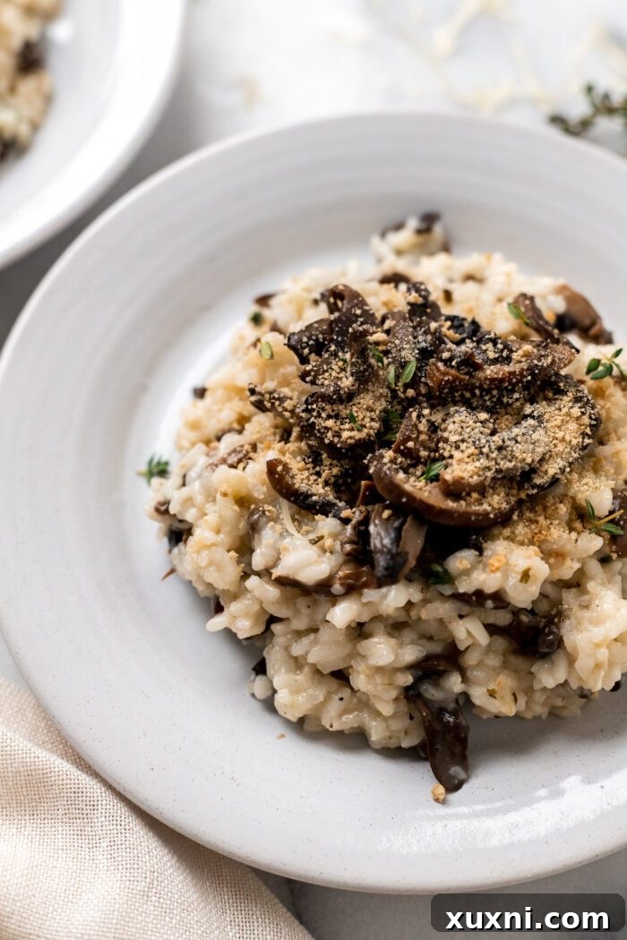 Close-up shot of a plate of perfectly cooked vegan risotto, showcasing its creamy texture.