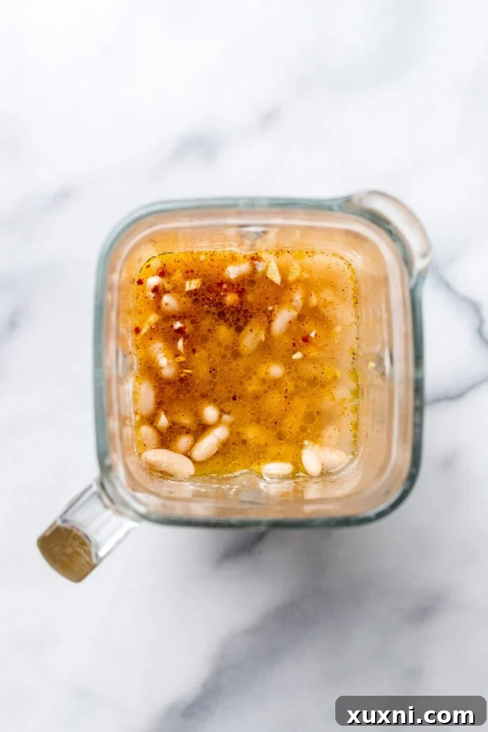 vegan queso ingredients before blending, inside a high-speed blender