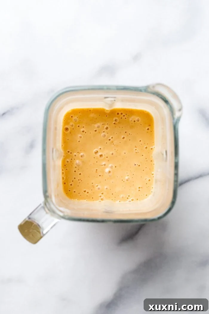 blended vegan queso, smooth and creamy, in a blender jar