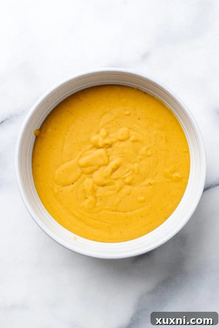 cooked vegan queso in a serving bowl, before adding toppings