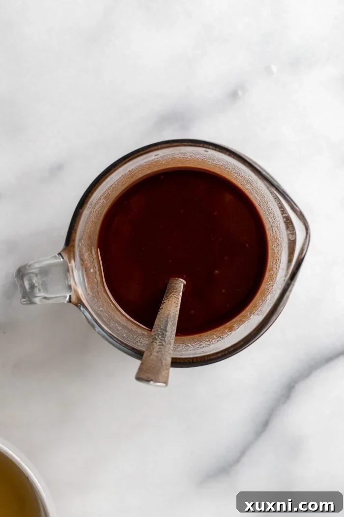 Melted vegan butter and chocolate chips stirred together in a bowl.