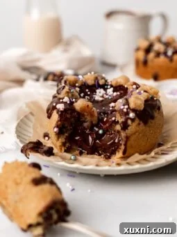 Vegan Mini Chocolate Chip Cookie Cakes Stuffed with Nutella on a plate with filling pouring out