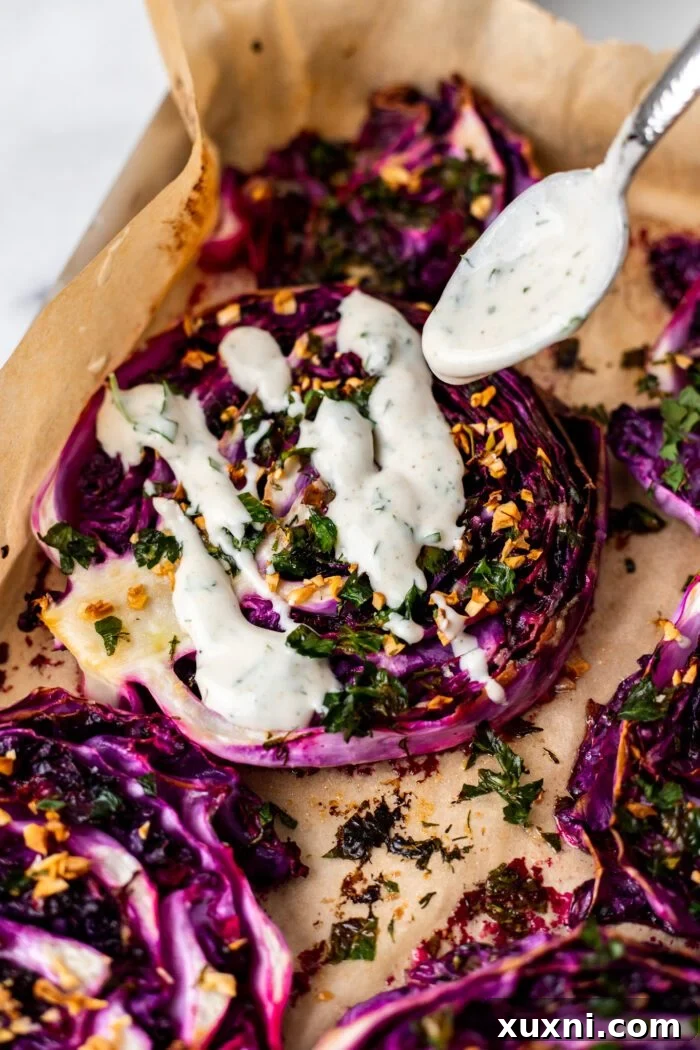 drizzling yogurt sauce onto roasted red cabbage