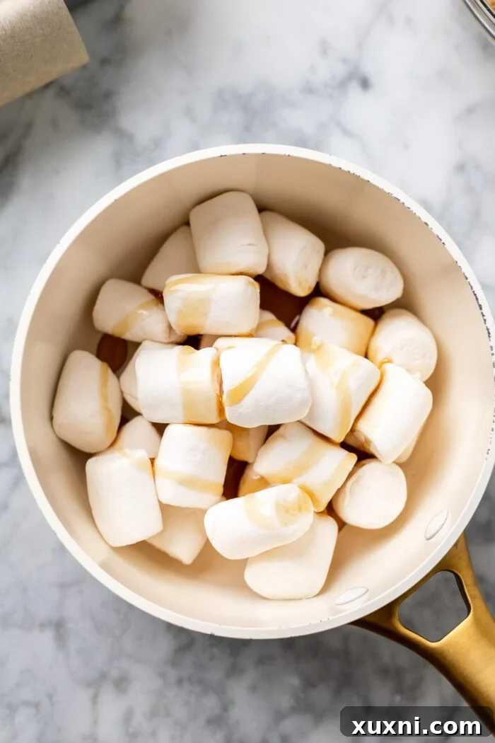 Vegan marshmallows melting in a pan with maple syrup for fluff