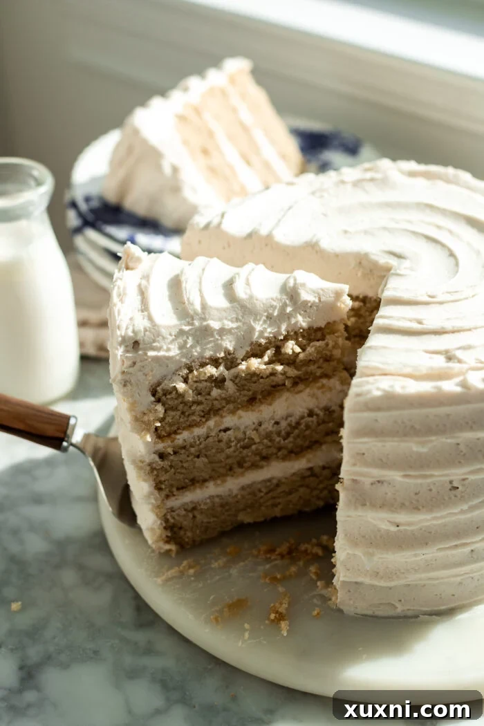 A close-up shot of a sliced vegan vanilla cake, revealing its perfectly moist and tender crumb.